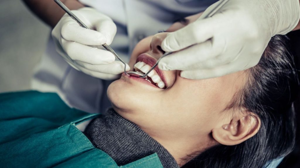 A woman receiving a dental check-up at Smiles Dentistry in Haverhill, FL, showcasing comprehensive dental services.