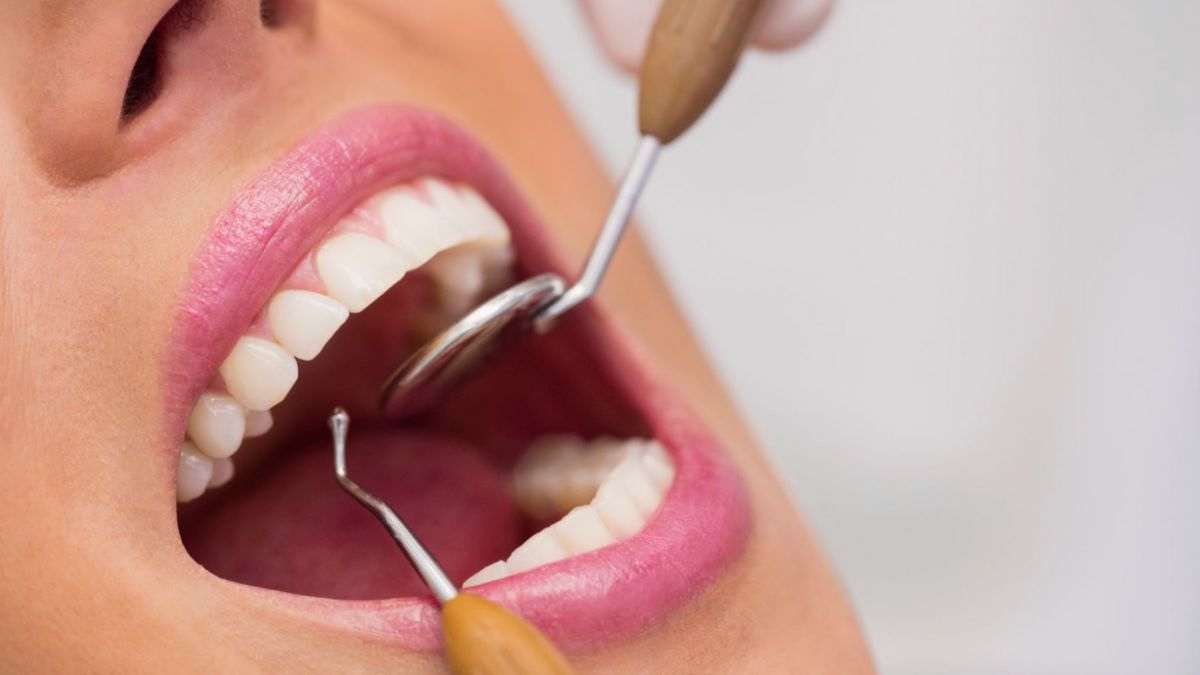 A woman undergoing a dental cleaning procedure, highlighting the services offered by Smiles Dentistry in Haverhill, FL.
