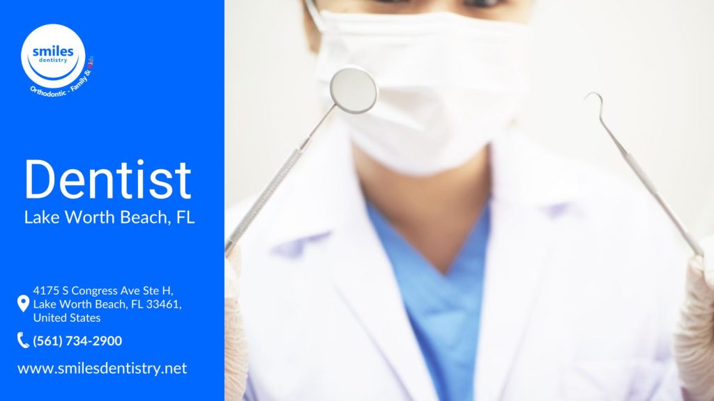 A dentist in a white coat and gloves displays two dental tools, showcasing her profession at Smiles Dentistry.