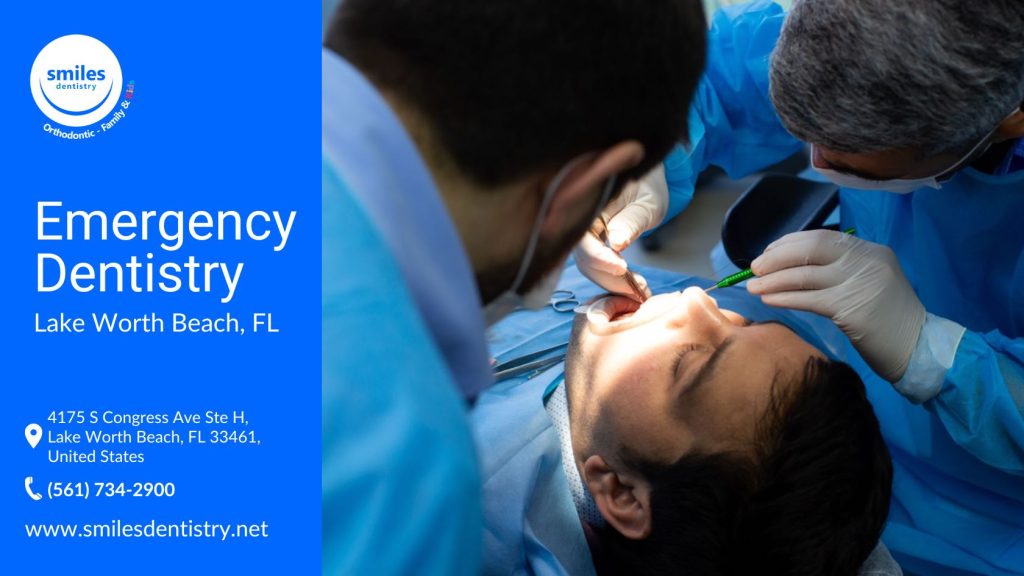 A dentist examines a man's teeth as he sits in a dental chair, wearing a blue suit.