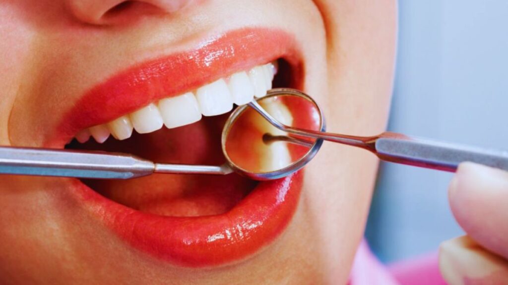 A woman undergoing a teeth cleaning procedure with a dental instrument at Gum Lift, Lake Worth, FL.